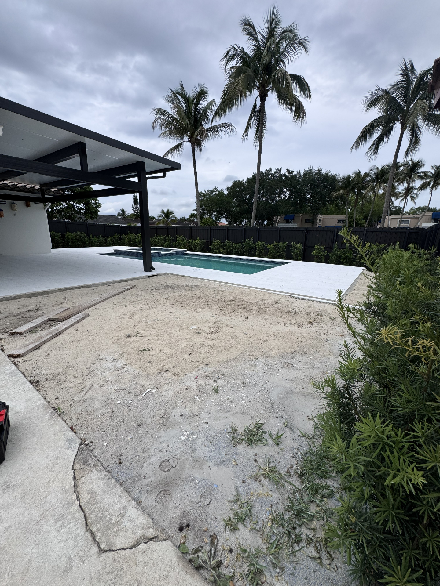Waterfront backyard artificial grass installation before and after before